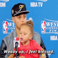 A Man Holding A Little Girl In Front Of A Nba Tv Sign GIF