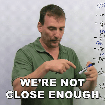 A Man Holding A Marker In Front Of A White Board With The Words We 'Re Not Close Enough GIF