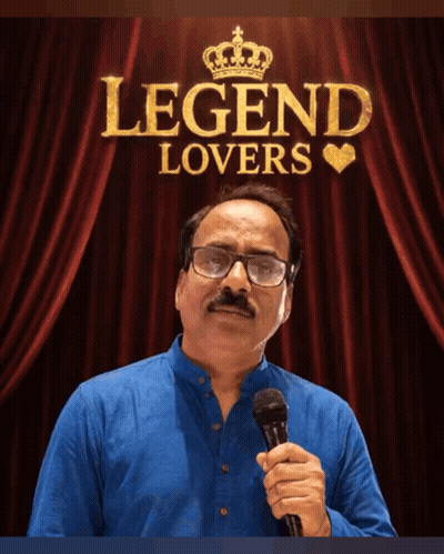 A Man Holding A Microphone In Front Of A Red Curtain That Says Legend Lovers On It GIF