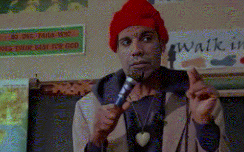 A Man Holding A Microphone In Front Of A Sign That Says " Walk In " GIF