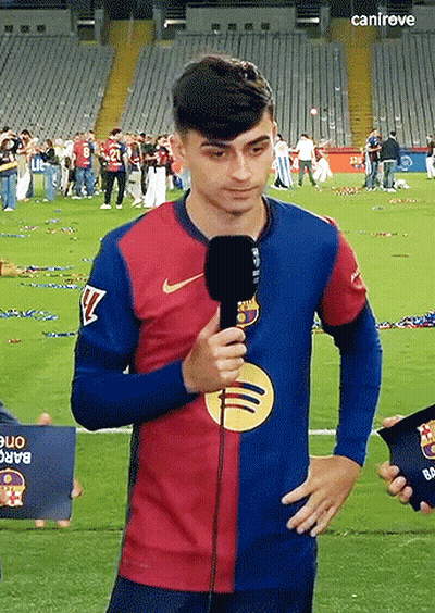 A Man Holding A Microphone On A Soccer Field With The Word Canireve On The Bottom Right GIF