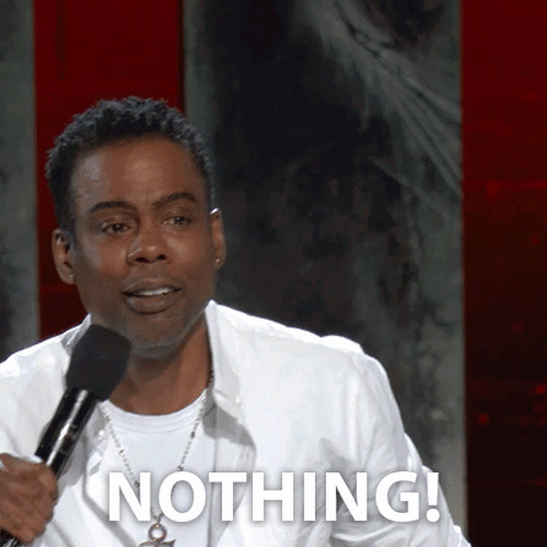 A Man Holding A Microphone Says Nothing In Front Of A Red Wall GIF