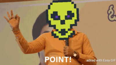 A Man Holding A Microphone With A Pixelated Skull On His Face And Point Written Below Him GIF