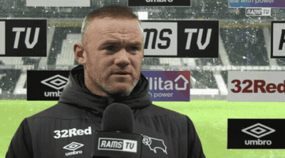 A Man Holding A Microphone With Rams Tv On It GIF