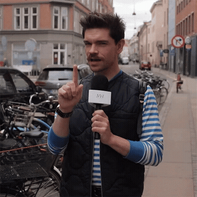 A Man Holding A Microphone With The Letter Mh On It GIF