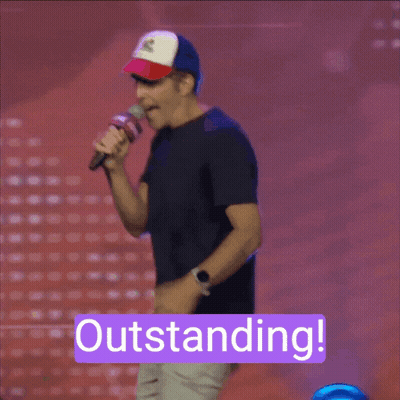 A Man Holding A Microphone With The Word Outstanding On The Bottom GIF