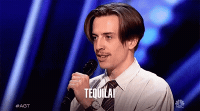A Man Holding A Microphone With The Word Tequila Written On It GIF