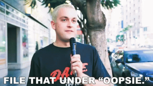 A Man Holding A Microphone With The Words File That Under Oopsie GIF