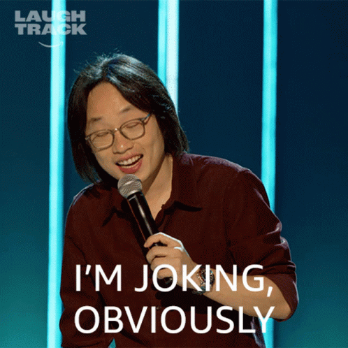 A Man Holding A Microphone With The Words I 'M Joking Obviously Above Him GIF