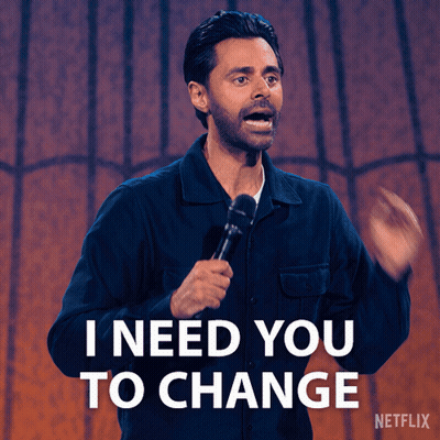 A Man Holding A Microphone With The Words I Need You To Change Behind Him GIF