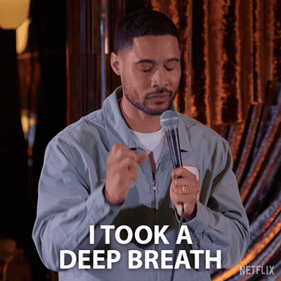 A Man Holding A Microphone With The Words I Took A Deep Breath Below Him GIF