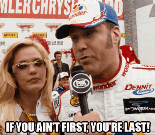 A Man Holding A Microphone With The Words If You Ain T First You 'Re Last On The Bottom GIF