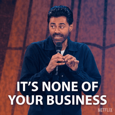 A Man Holding A Microphone With The Words It 'S None Of Your Business GIF