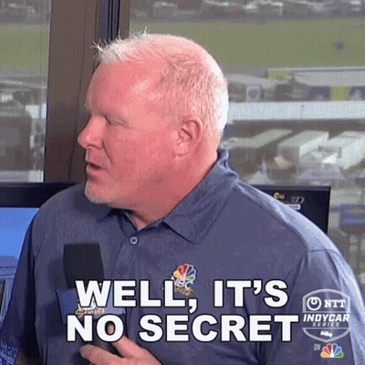 A Man Holding A Microphone With The Words Well It 'S No Secret On His Shirt GIF