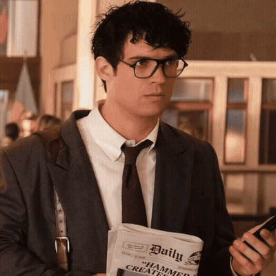 A Man Holding A Newspaper That Says Daily GIF