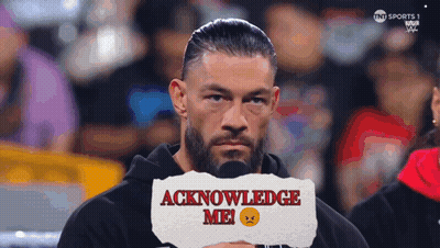 A Man Holding A Piece Of Paper That Says ' Acknowledge Me ' On It GIF
