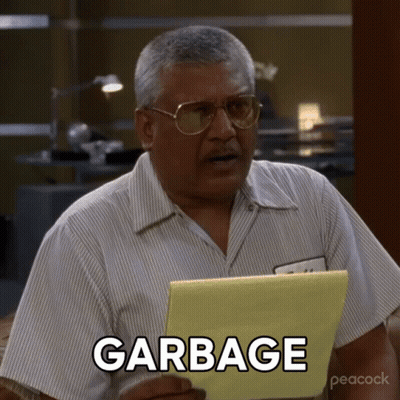 A Man Holding A Piece Of Paper That Says Garbage On It GIF