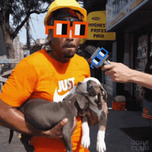 A Man Holding A Puppy In Front Of A Sign That Says Higher Prices Paid GIF