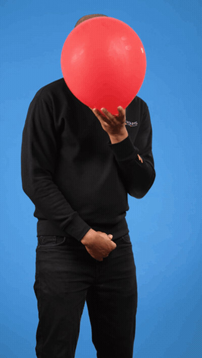 A Man Holding A Red Balloon In Front Of His Face Wearing A Black Sweatshirt That Says ' Balenciaga ' On It GIF