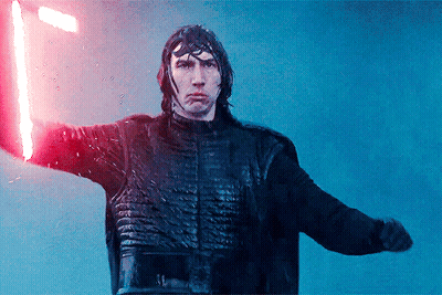A Man Holding A Red Light Saber In His Hand GIF