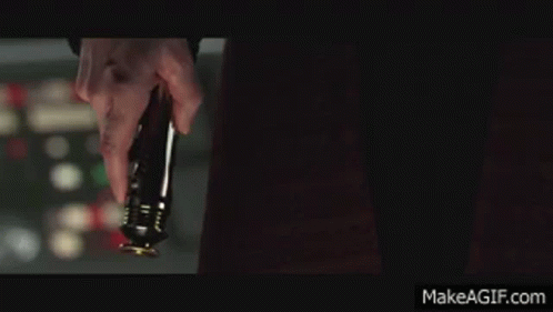 A Man Holding A Red Lightsaber In Front Of A Makeagif.com Logo GIF