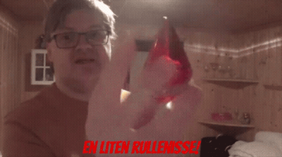 A Man Holding A Red Object With The Words En Uten Rullenisse In Red GIF