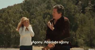 A Man Holding A Rifle With Agony Absolute Agony Written Below Him GIF