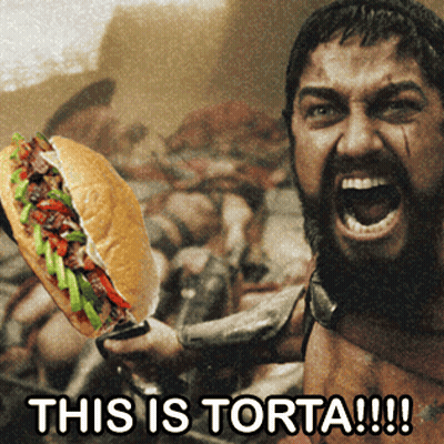 A Man Holding A Sandwich With The Words " This Is Torta !!! " On The Bottom GIF