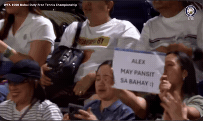 A Man Holding A Sign That Says Alex May Pansit Sa Bahay On It GIF