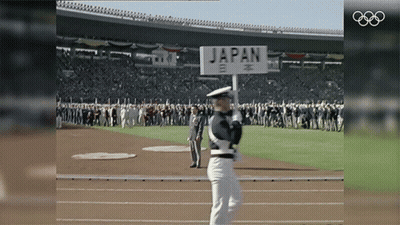 A Man Holding A Sign That Says Japan GIF