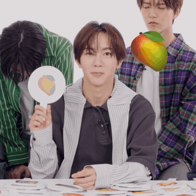 A Man Holding A Sign That Says Peach On It GIF