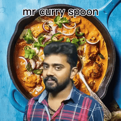 A Man Holding A Spoon In Front Of A Pan Of Curry GIF