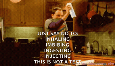 A Man Holding A Spray Bottle In A Kitchen Says Just Say No To Inhaling Imbibing Ingesting Injecting GIF
