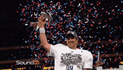 A Man Holding A Super Bowl Trophy With Confetti Falling Around Him GIF