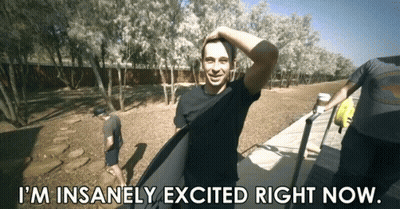 A Man Holding A Surfboard With The Words I 'M Insanely Excited Right Now GIF