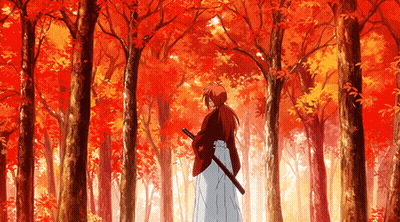 A Man Holding A Sword In A Forest With Red Leaves On The Trees GIF