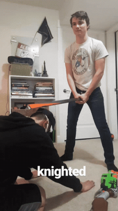 A Man Holding A Sword Next To Another Man With The Word Knighted On The Bottom GIF