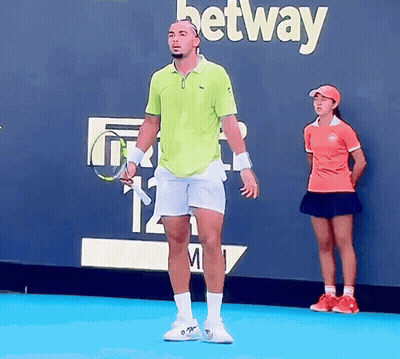 A Man Holding A Tennis Racquet In Front Of A Betting Wall GIF