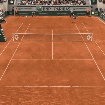 A Man Holding A Tennis Racquet In Front Of A Bnp Banner GIF