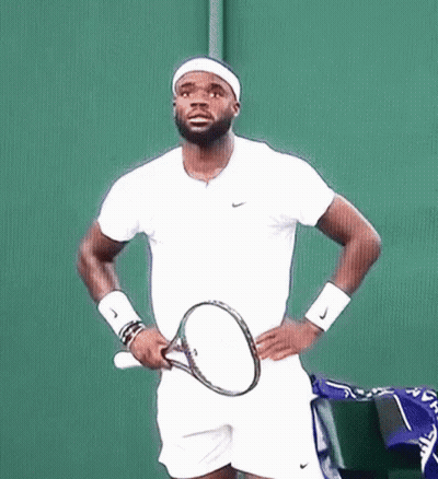 A Man Holding A Tennis Racquet On A Court GIF