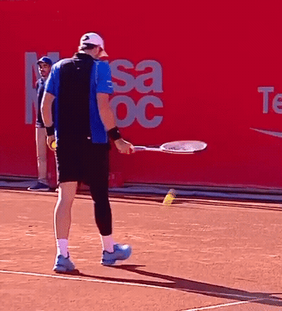 A Man Holding A Tennis Racquet On A Tennis Court In Front Of A Sign That Says Sa Oc GIF