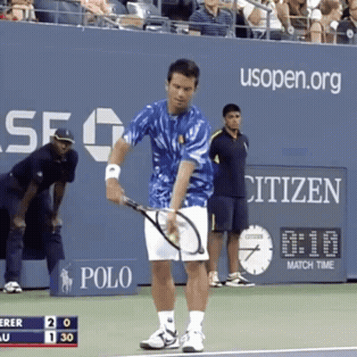 A Man Holding A Tennis Racquet On A Tennis Court With A Citizen Sign In The Background GIF