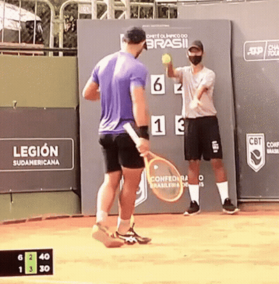 A Man Holding A Tennis Racquet Stands In Front Of A Sign That Says Legion GIF