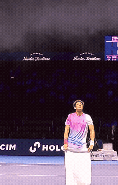 A Man Holding A Towel On A Tennis Court In Front Of A Nicolas Feuillatte Sign GIF