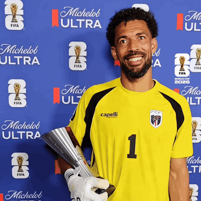 A Man Holding A Trophy In Front Of A Wall That Says Michelob Ultra GIF