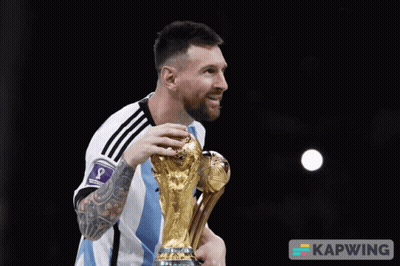 A Man Holding A Trophy That Says Kapwing On The Bottom Right GIF