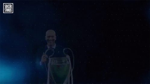 A Man Holding A Trophy With The Word Zidane On The Bottom GIF
