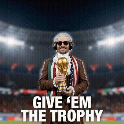 A Man Holding A Trophy With The Words Give ' Em The Trophy Below Him GIF