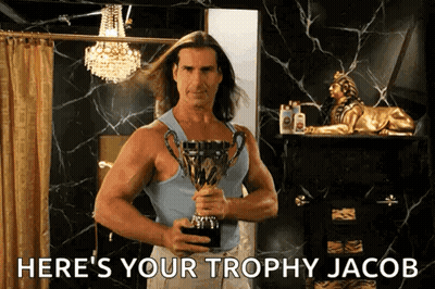 A Man Holding A Trophy With The Words Here 'S Your Trophy Jacob GIF