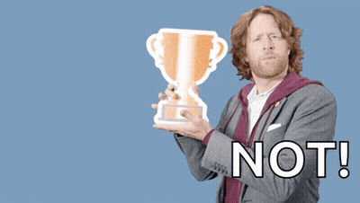 A Man Holding A Trophy With The Words " You Deserve A Trophy Not " Behind Him GIF